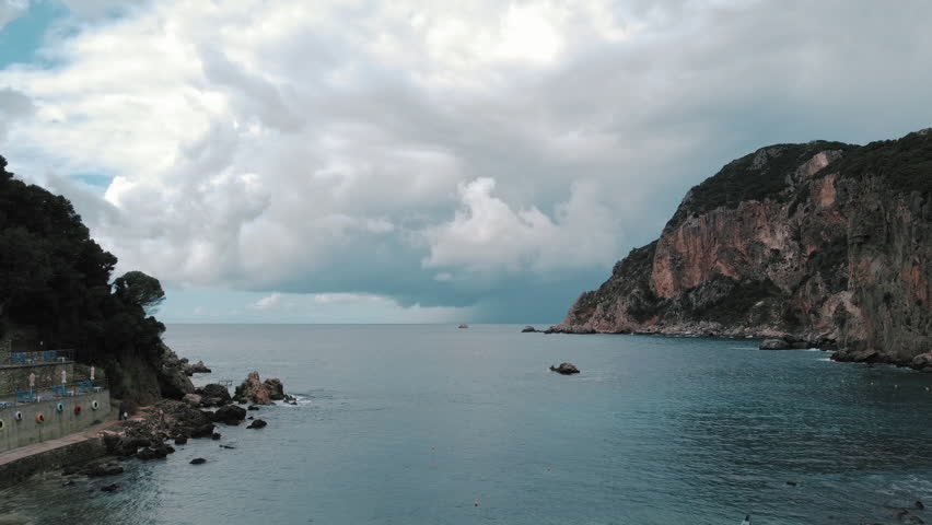 Drone view to sea, rocks and cloudy sky. Greece, Corfu, Palaiokastritsa