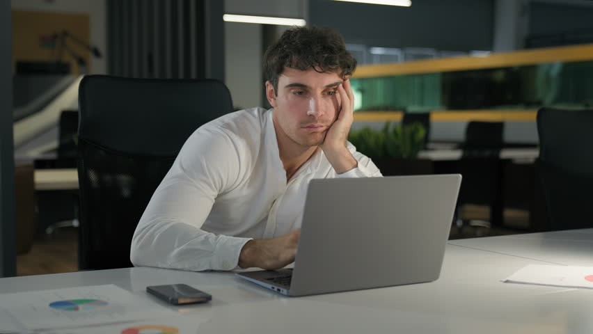 Tired exhausted Caucasian businessman bored fatigued male designer with computer project sad overworked overtime working at creative modern office business man employer work laptop boring deadline Royalty-Free Stock Footage #1112118123