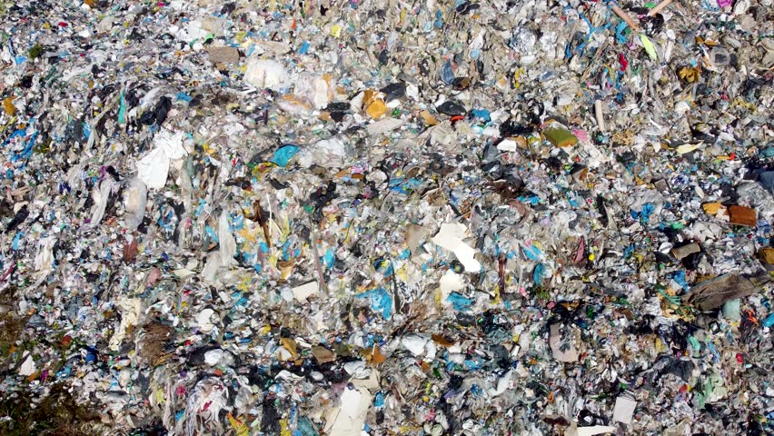 Open landfill site with piles of waste. Aerial drone view of garbage dump near a city. Environmental pollution. Plastic bags, packing and pet bottles. Tons of trash. | Shutterstock HD Video #1112119573