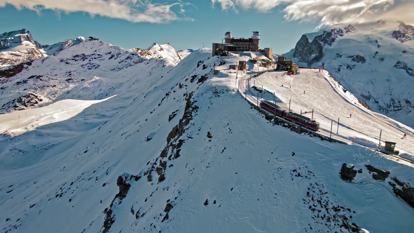 Aerial view of cog railway train ride to the Gornergrat Observation Platform in Zermatt. View from above of the Observation deck in Zermatt, Switzerland during snow in winter time.