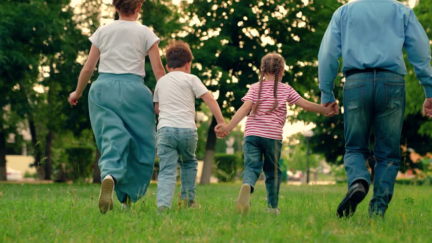 Happy family team, children, parents, run together in park on grass. Weekend play, holiday kids. Children, mom dad playing, kids in nature. Family game Concept, father mother daughter son fun running Royalty-Free Stock Footage #1112120883