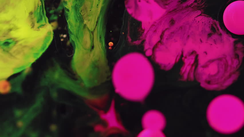 Abstract colorful background. Acrylic bubbles. Oily art. Black pink green yellow paint fluid splatter spots stains spreading on water surface.
