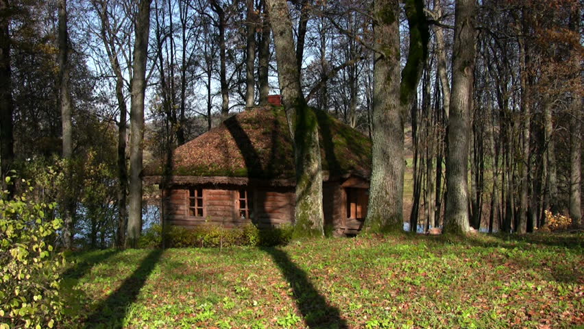 Log cabin in autumnal park 