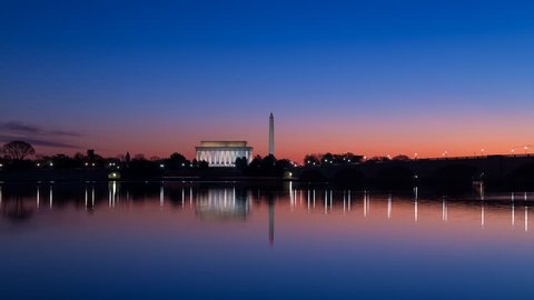 Time lapse of a sunrise on the Lincoln Memorial and Washington Monument as seen across from the Potomac River.