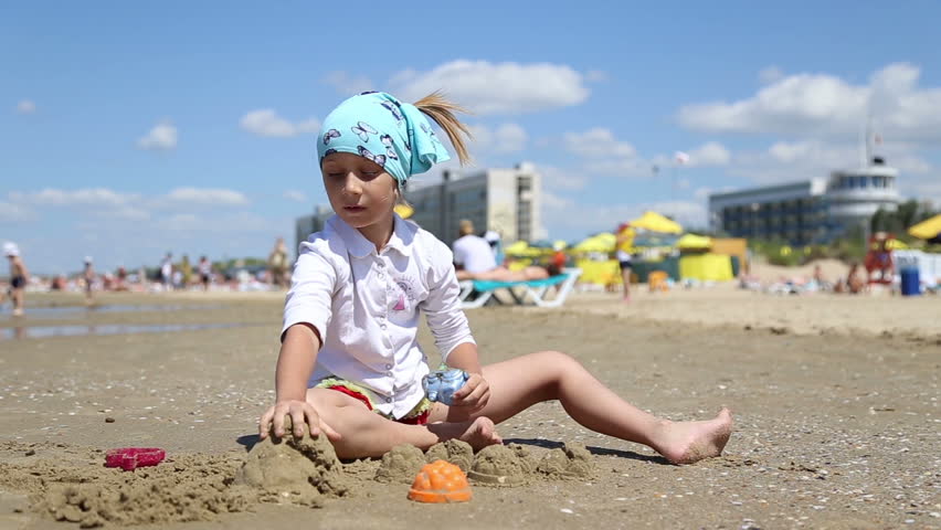 ANAPA, KRASNODAR REGION/RUSSIA - JULE 01: Little girl playing with sand on the beach in the Black Sea on Jule 01, 2015 in Anapa
