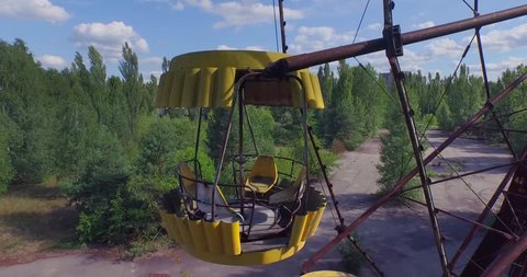Aerial drone footage. A Ferris wheel in Pripyat, near Chernobyl.The giant Ferris wheel was never loaded. The park was only opened for one day, and almost immediately abandoned. 4K.