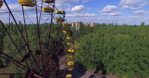 Aerial drone footage. A Ferris wheel in Pripyat, near Chernobyl.The giant Ferris wheel was never loaded. The park was only opened for one day, and almost immediately abandoned. 4K