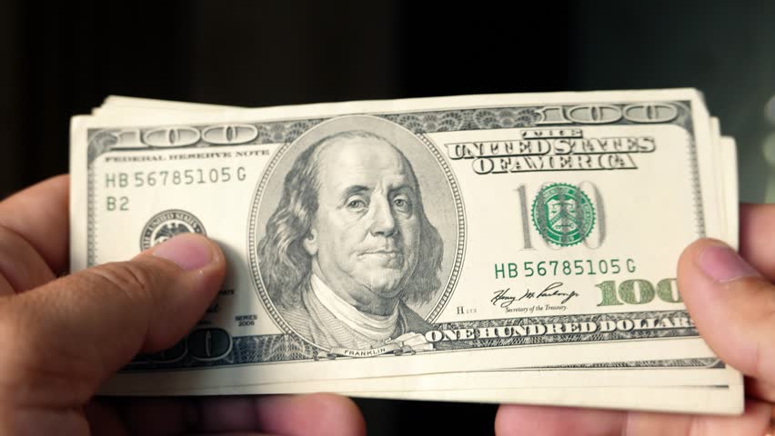 Person counting money in hands. lot of one hundred US dollars banknotes. Cash, money, ready money, Finance & Business. Financial income, wages, sell, loan. Festive celebration and gala