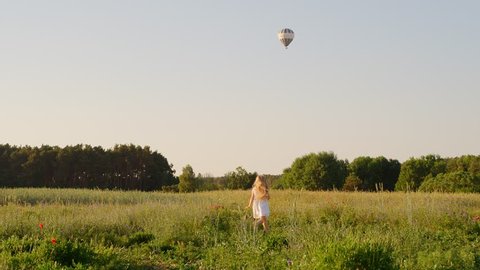 Happy Little Girl Playing Outdoor, Flower Field, Summer, Spring Landscape, Hot-air balloon, Slow motion