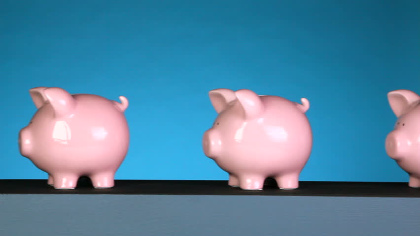 A line of piggy banks goes past an x-ray machine, that shows one empty, then a