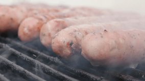 Raw sausage  made from ground meat grilling on barbecue smoke 4K 2160p 30fps UHD video - Mixed meat delicious sausage grilled on bbq fire 4K 3840X2160 UltraHD footage