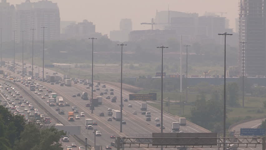 Toronto, Ontario, Canada July 2015 Haze and smog covers Toronto skyline and highway on hot summer day
