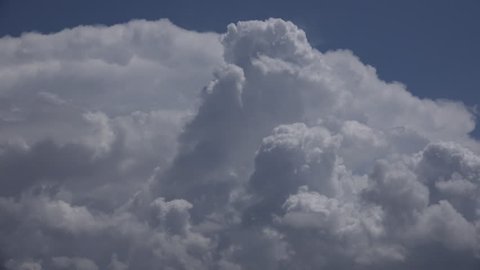 Time Lapse, Fluffy, rising mounds of cumulus storm clouds, the texture of whipped cream, expand in hazy blue sky during summer monsoon season. 4K UHD 3840x2160