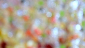 blurred background of white, green, red, grey colors. defocused empty glasses with green cherries ready for party