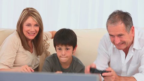 Family playing to video games in the living room