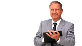 Elderly businessman taking notes isolated on a white background - Powered by Shutterstock - Get 15% off with code: PIKWIZARD15