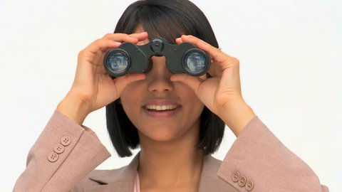 A cute business woman looking at someone through binoculars