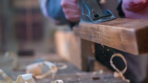 In the woodworkers shop is useless pieces of wood flaying around the place ,close up footage in slow motion.