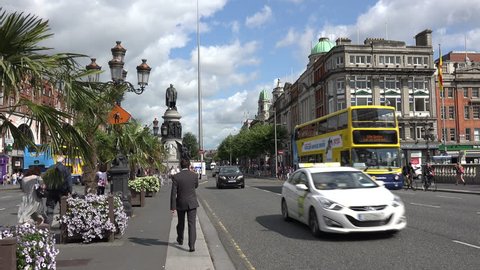 DUBLIN, LEINSTER/IRELAND - JULY 15, 2015: Unidentified people and traffic cross Oconnell street Bridge. O'Connell Street is named after Daniel O'Connell, a nationalist leader.

