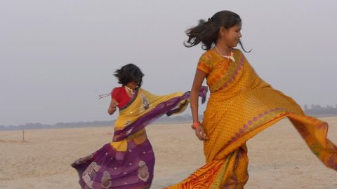 Indian young women dancing near the Ganges river in the vicinity of Varanasi city, march 2015