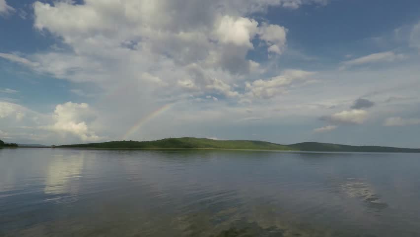 Rainbow background landscape footage.
time-lapse footage over a lake reflecting slow moving clouds in calm wind water.
Ultra HD, 4K