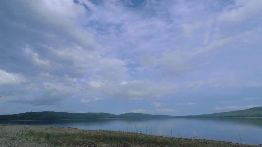Storm clouds 4k footage time-lapse over a lake.
moving clouds footage. Ultra HD.