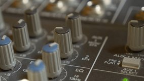 Sound mixing console buttons and dials close-up 4K 2160p 30fps UltraHD panning video - Professional audio mixer soundboard music technology slow pan 4K 3840X2160 UHD footage
