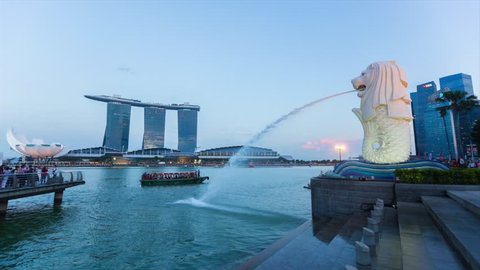 MARINA BAY, SINGAPORE - JULY 30, 2015: Time lapse of the iconic Merlion statue at dusk on July 30, 2015 in Singapore.