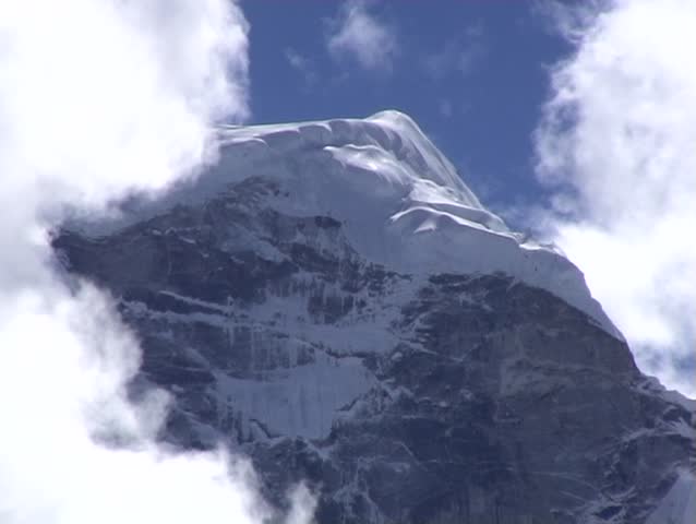 2 Dramatic views of clouds over a mountain peak in the Khumbu region of Nepal.
