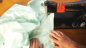 An elderly woman working on an old sewing machine. - Powered by Shutterstock - Get 15% off with code: PIKWIZARD15