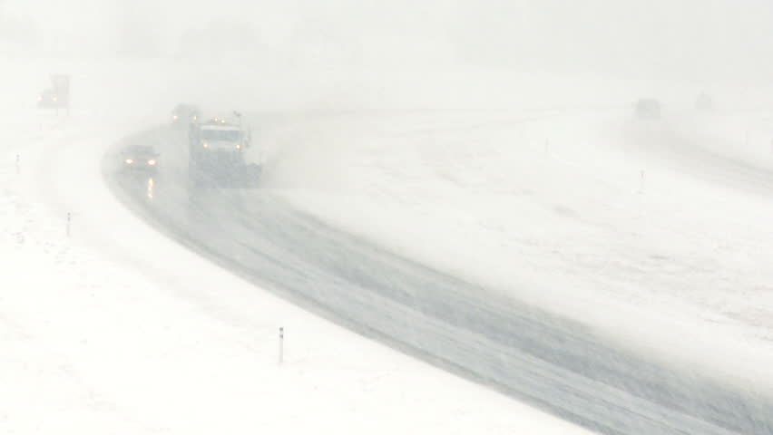 Highway snowplow during blizzard