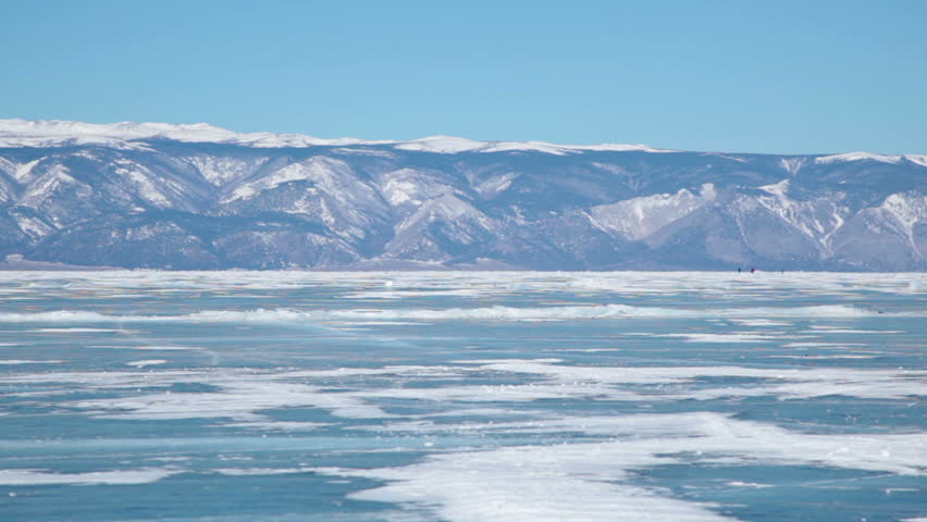 People travel on frozen Lake Baikal 
Extreme winter journey across the ice deep reservoir