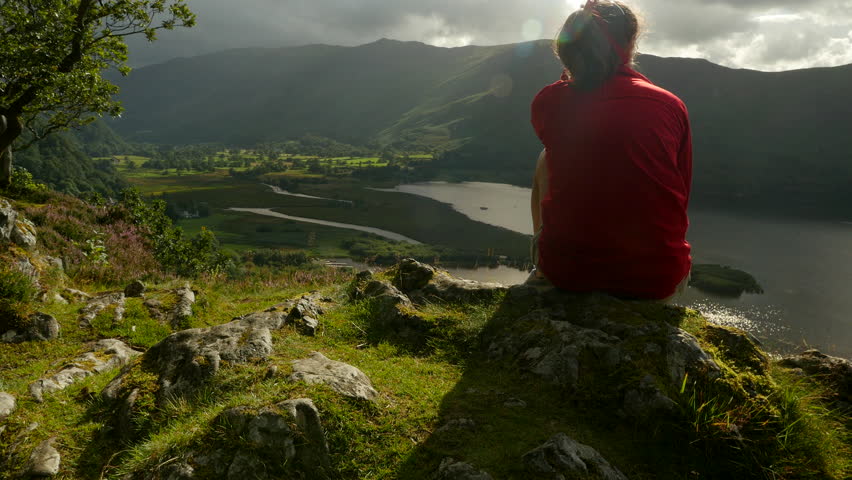 Jib shot of Surprise View in English Lake District with woman looking out to Derwent Water.