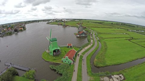 Zaandam Zaanse Schans aerial bird eye helicopter view slalom through the windmills one of the most popular tourist attractions in Netherlands Holland exists of wooden wind barns houses and museums 4k