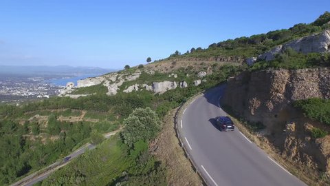 AERIAL: SUV car driving along the mountain road in France Stock Video