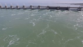 Aerial Drone Video (Ultra HD) of the famous Dutch Delta Works. Seawater barriers engineered  for sea level protection. Camera: Steady POV forward approach and passing by.