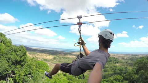 POV Young Happy Man Zip Lining In Tropical Jungle