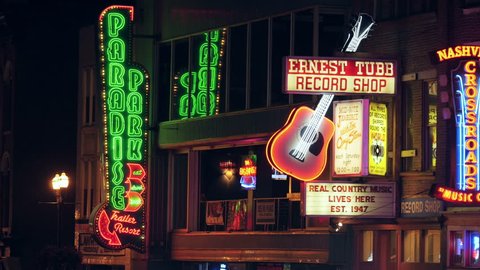 NASHVILLE - AUGUST 13: Neon signs of the Honky-tonks and other tourist attractions light up Broadway in The District on August 13, 2015 in Nashville, Tennessee.