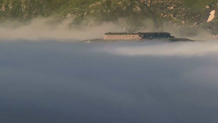 Variselle mountain fort fog flowing below summer time lapse 