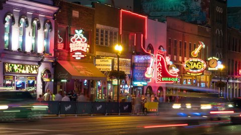 NASHVILLE - AUGUST 13: (Timelapse/Zoom-in) People and vehicular traffic travel on Lower Broadway visiting Honky-tonks and other tourist attractions in on August 13, 2015 in Nashville, Tennessee.