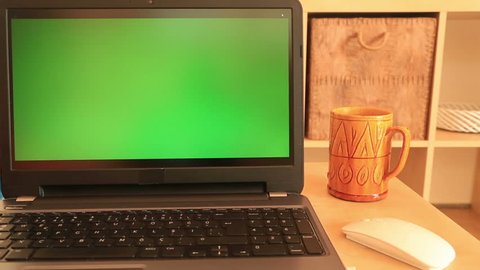 Woman working with  green screen Choma-key laptop monitor