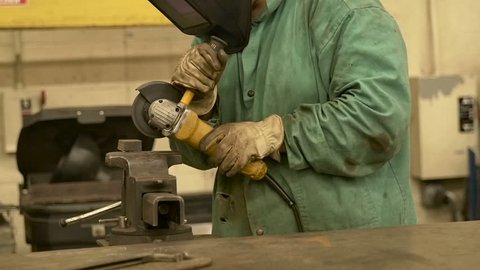 Welding Operator Working with an Industrial Grinder in a Metal Shop