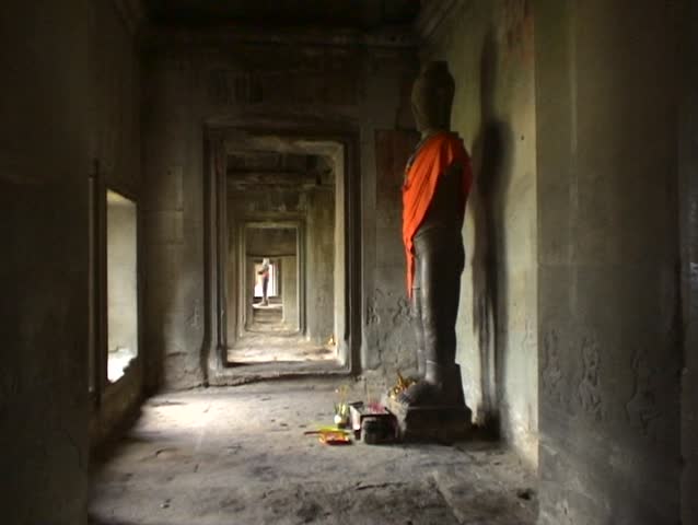 Buddha statue with offerings in Angkor Wat, Cambodia.