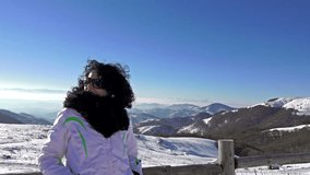 4k happy women facing camera and enjoying winter day. snow landscape at high mountain peak, uhd steadycam stock video