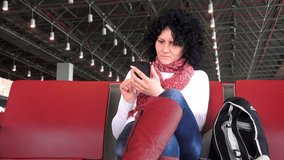 Woman texting on smartphone at train station. 4K UHD stock video