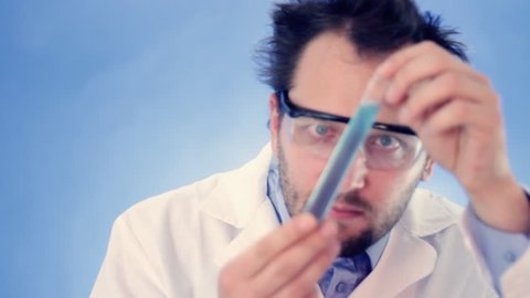 Male scientist injecting substance from syringe into test tube