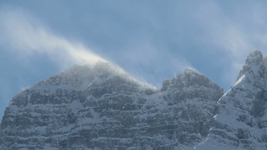 Snow spindrift blowing off mountain peak