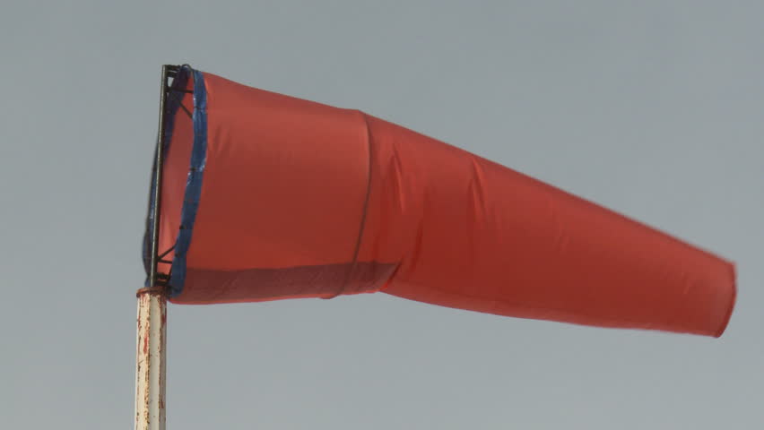 Windsock blowing in the wind at an airport
