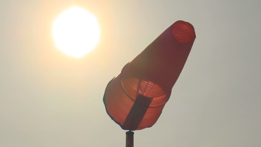 Windsock blowing in the wind at an airport