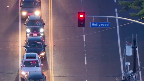 Hollywood Boulevard street sign with motion blurred car traffic behind it. Los Angeles, California. Timelapse.